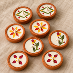 Dried-Flower Soy Wax Terracotta Diyas, Set of 16, close-up of the pressed flowers