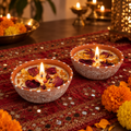 Rose and Marigold Soy Wax Candles in Terracotta, Set of 2, lit for Diwali on a mirror-work runner