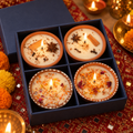 Floral and Spice Terracotta Candle Gift Box, Set of 4, lit for Diwali on a mirror-work runner
