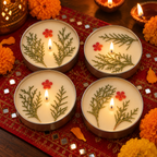 Lemongrass Soy Wax Tin Candles with Dried Flowers, Set of 4, lit for Diwali on a mirror-work runner