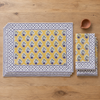 Mustard Floral Placemat and Napkin Set of 12, placemats and napkins stacked, seen from above