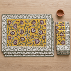 Turmeric Yellow Floral Placemat and Napkin Set of 12, placemats and napkins stacked, seen from above