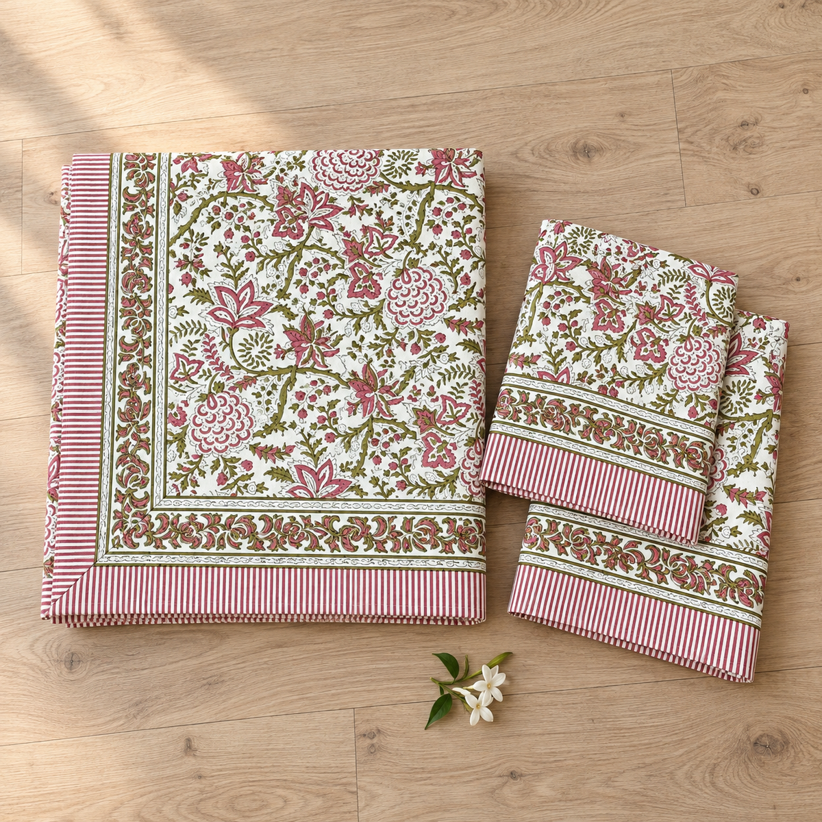 Pink and Green Floral Bedsheet Set, folded with its pillow covers