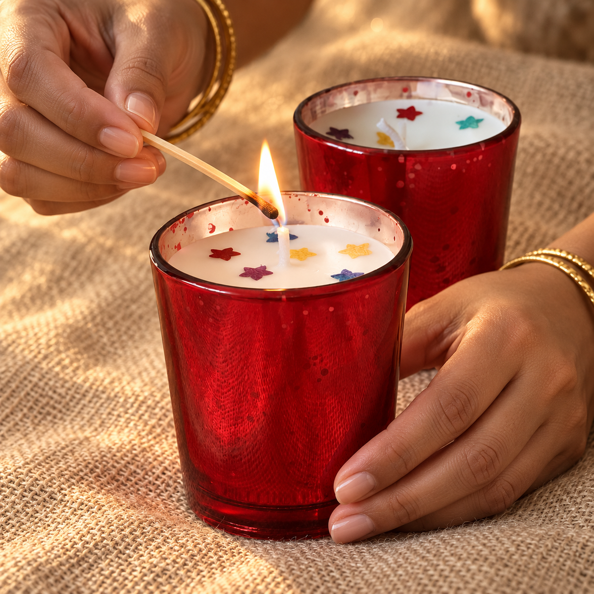 Red Glass Rose-Scented Soy Wax Candles, Set of 2, being lit by hand