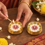 Pressed-Flower Brass Urli Candles, Set of 2, being lit by hand