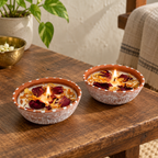 Rose and Marigold Soy Wax Candles in Terracotta, Set of 2, on a teak console in daylight