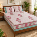 Pink Floral Buta Bedsheet Set, on a made double bed in a bright bedroom