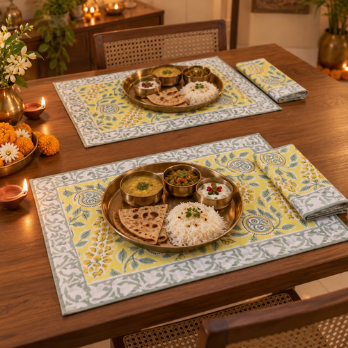 Bright Yellow Floral Placemat and Napkin Set of 12, set for a Diwali meal with brass thalis and diyas