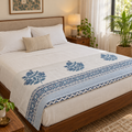 Blue Floral Buta Dohar, folded at the foot of a made bed