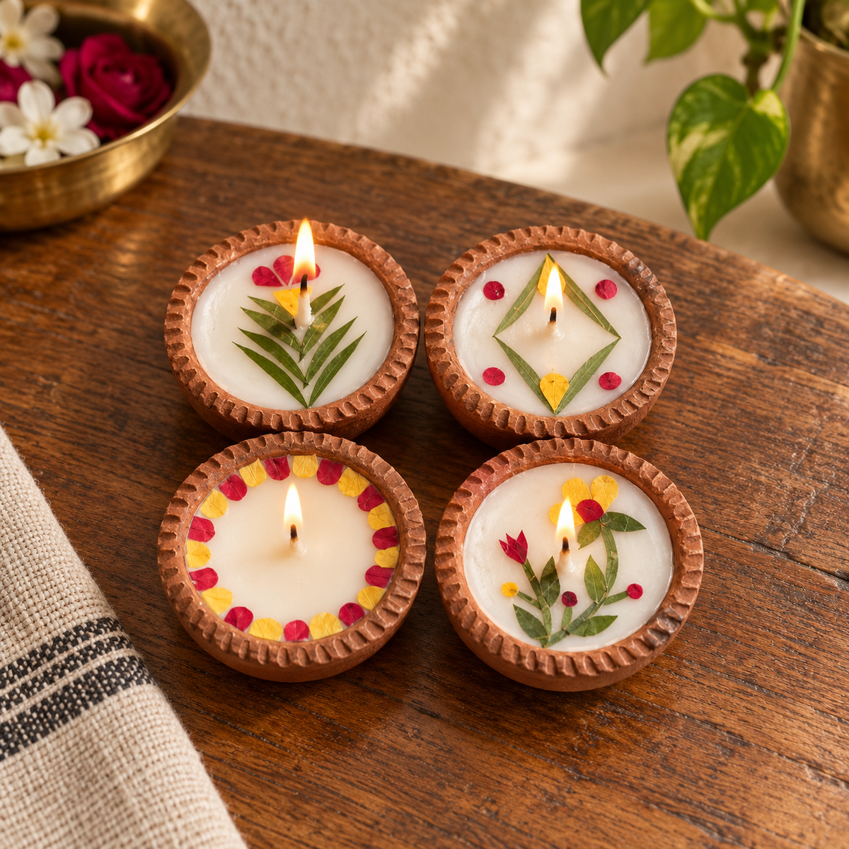 Small Soy Wax Diyas with Flower Petals, Set of 4, on a teak console in daylight