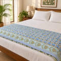 Blue Floral Dohar, folded at the foot of a made bed