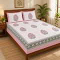 Pink Floral Buta Bedsheet Set, on a made double bed in a bright bedroom