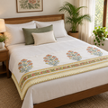 Orange Floral Dohar, folded at the foot of a made bed