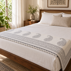Grey Paisley Dohar, folded at the foot of a made bed