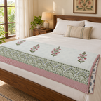 Pink Floral Buta Dohar, folded at the foot of a made bed